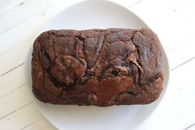 loaf of chocolate pumpkin swirl bread on a plate