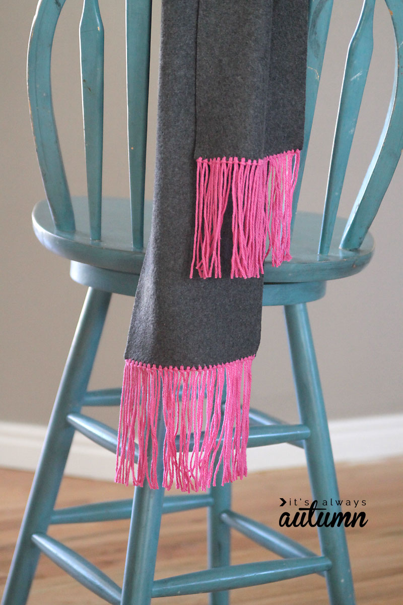 Scarf with yarn fringe hanging over a stool