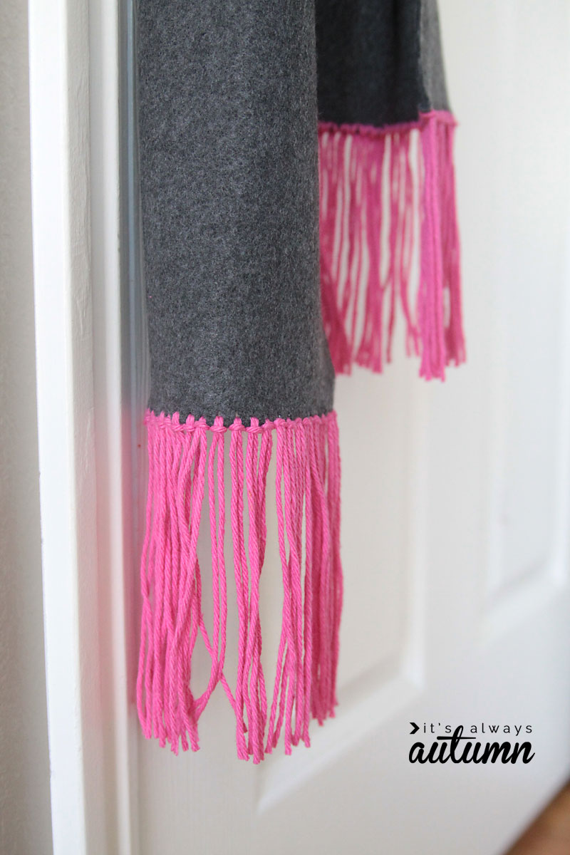 A fleece scarf with pink fringe