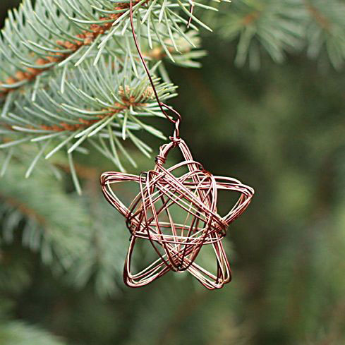 DIY wire star ornament hanging on a Christmas tree