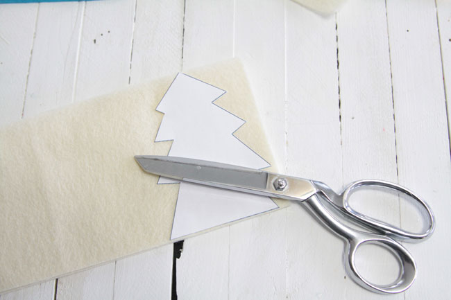 cutting a christmas tree shape out of cream felt