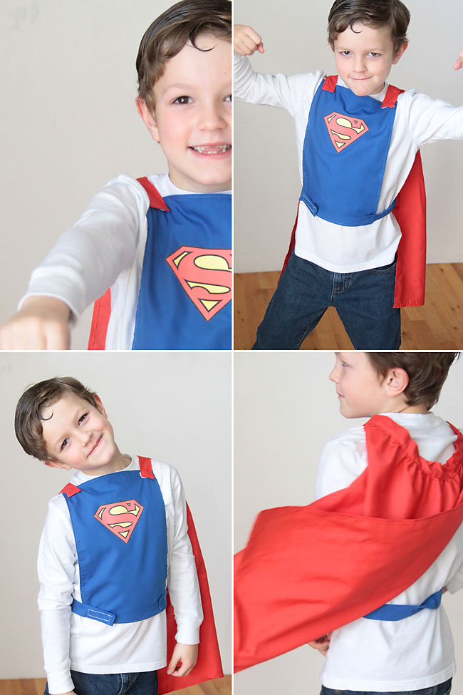 A young boy playing in a homemade superhero cape