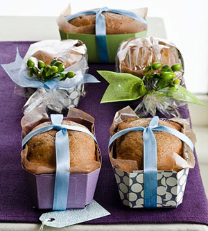 mini loaves of bread in cute paper containers tied with ribbon