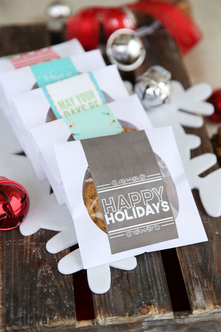 CD envelopes with a cookie inside each and a happy holidays tag