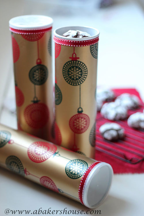pringles containers wrapped in christmas paper to hold cookies