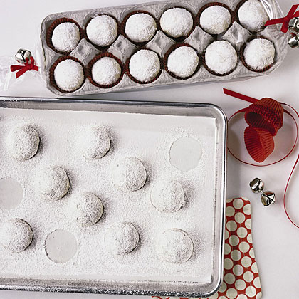powdered sugar covered cookies in an egg carton