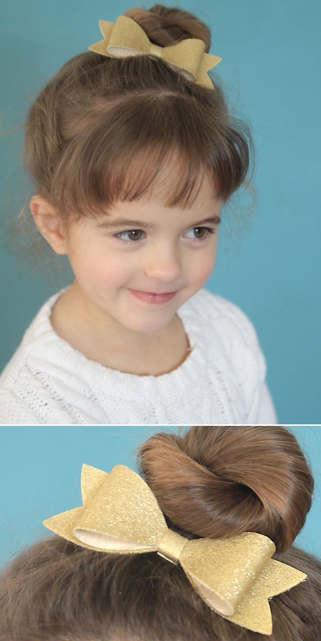 A little girl with a gold bow in her hair