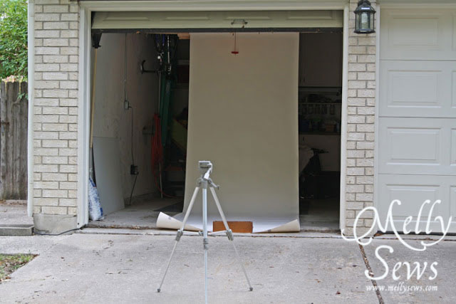 Seamless paper hanging in a garage with a tripod in front of it