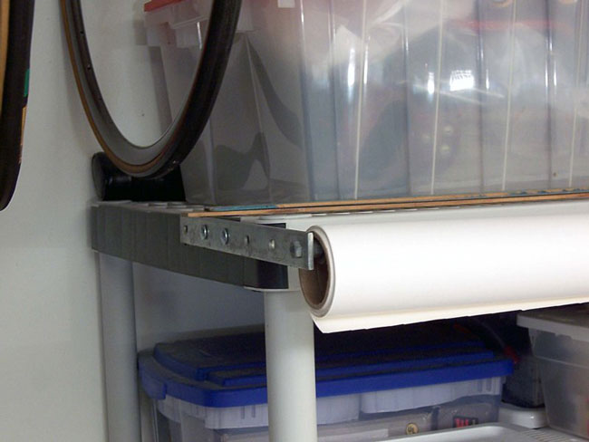 Garage shelves with photography paper roll attached