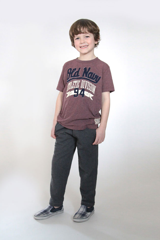 A young boy wearing a pair of slim fit sweats