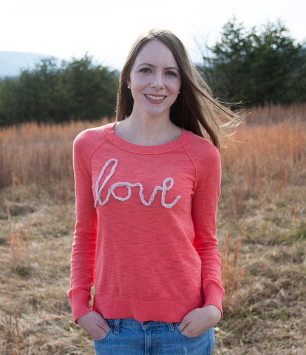 A woman wearing a red t-shirt with the word love on it