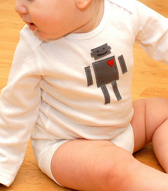 A baby with a robot with a heart on his shirt