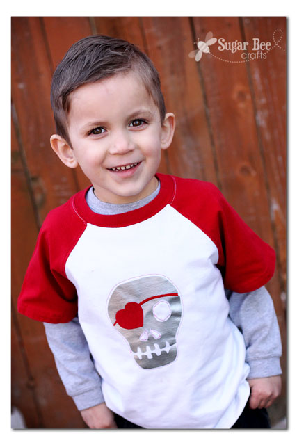 A boy wearing a t-shirt with a skeleton face with a heart eye patch