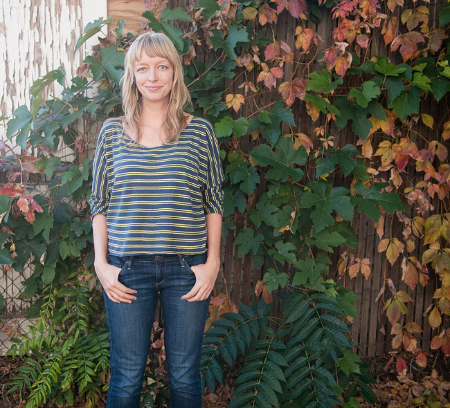 A woman wearing a t-shirt with loose elbow length sleeves