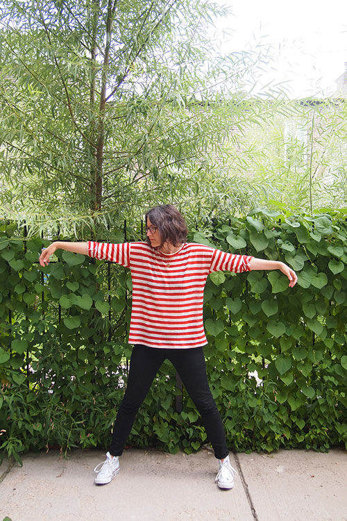 A woman in a park wearing a boxy t-shirt made from a sewing pattern