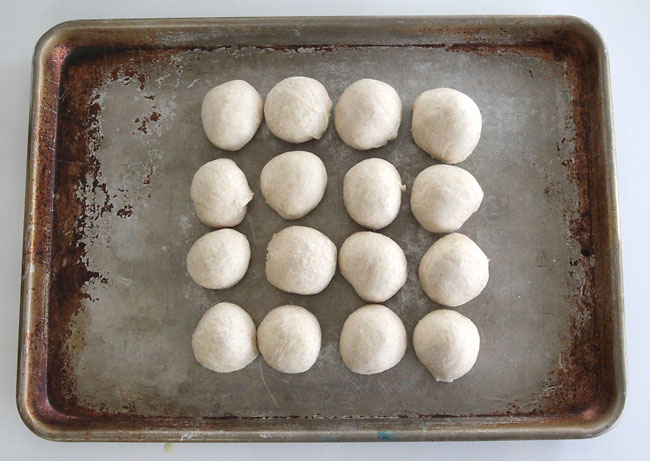 Balls of roll dough on a baking sheet
