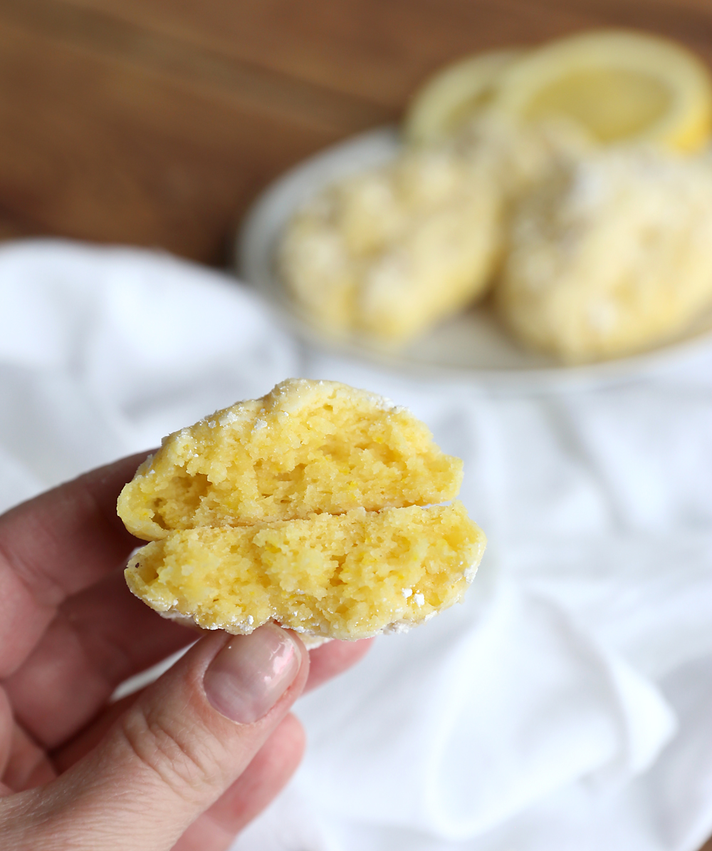 Hand holding a lemon cake mix cookie broken in half