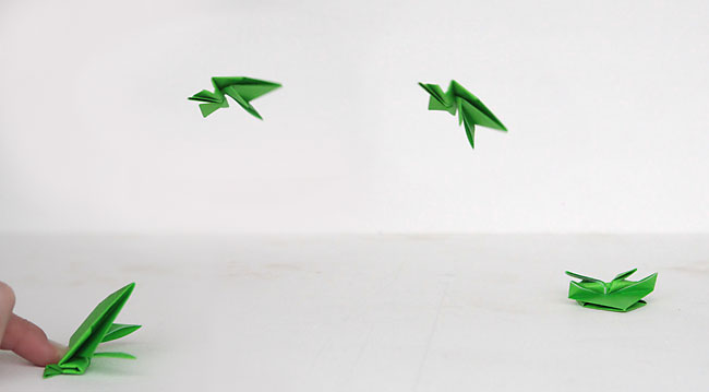 Origami frog flying through the air