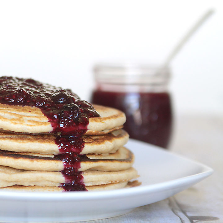A stack of pancakes topped with low sugar berry topping
