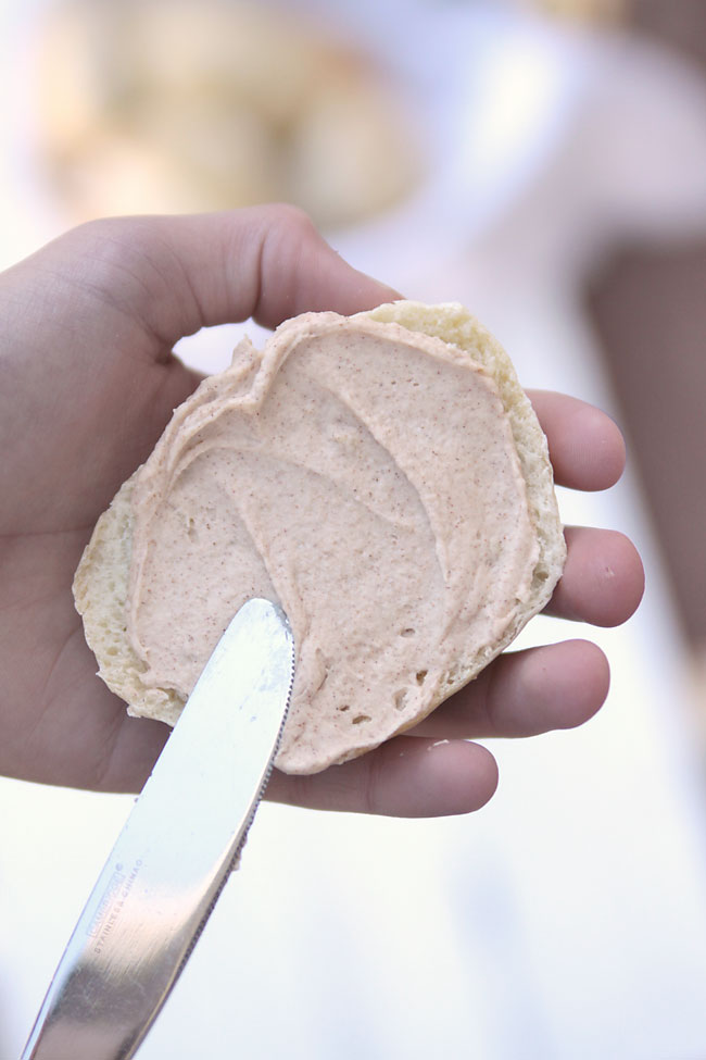 A roll half spread with cinnamon honey butter