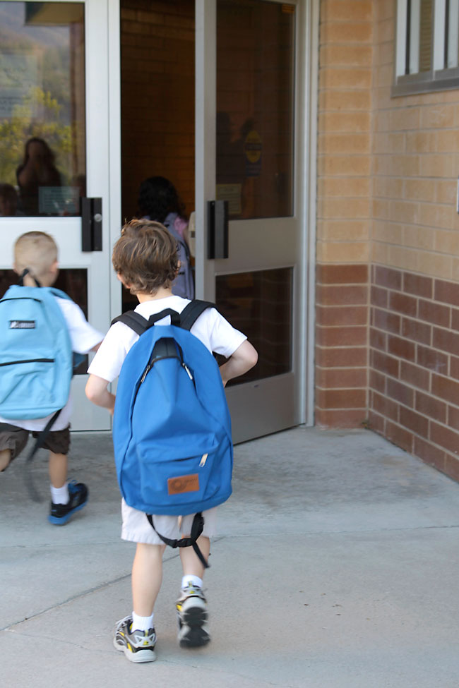 Little kids walking into school