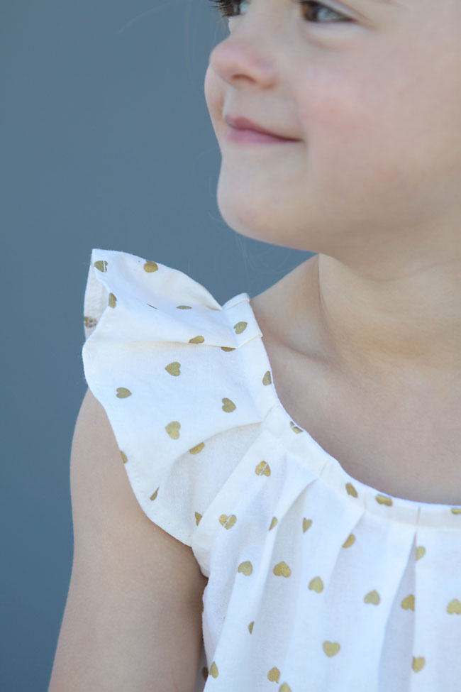Closeup of a pleated flutter sleeve on a girls dress