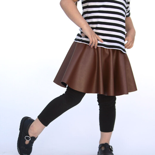 A girl wearing a circle skirt made from faux leather