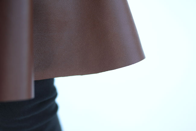 close up of a faux leather circle skirt with raw hem