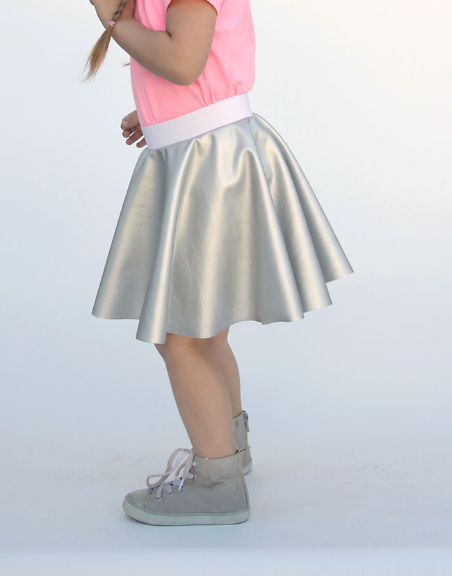 A girl wearing a silver circle skirt