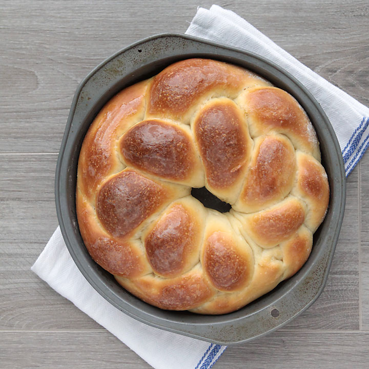 Loaf of braided bread in a round tin