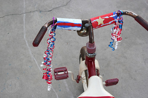 A tricycle with handlebars decorated for 4th of July