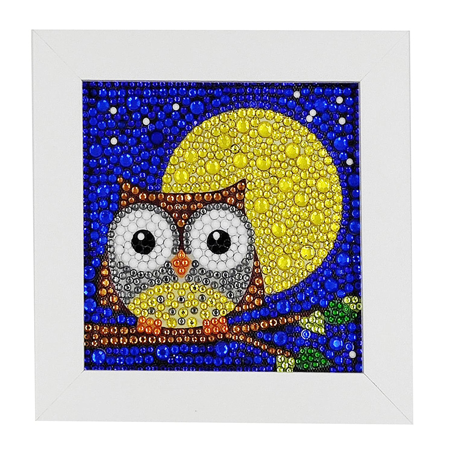 Photo of an owl in front of the moon created with gem art