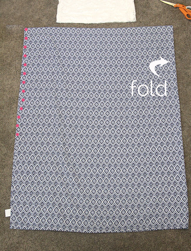A large piece of fabric folded on one side with a seam marked down the other