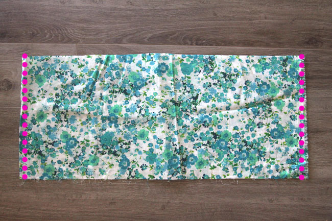 A wide piece of floral fabric with side seams marked