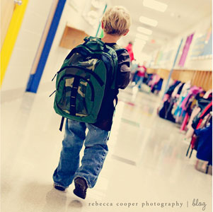 Boy walking down a school hallway