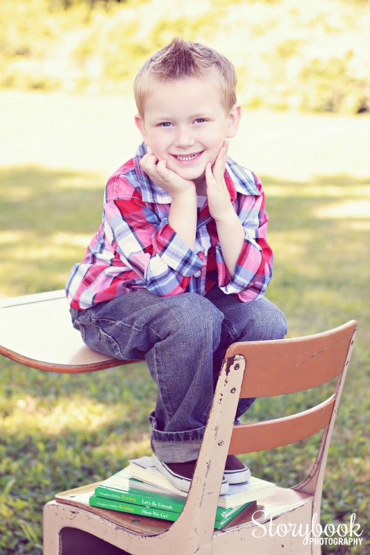 Smiling boy sitting on a desk