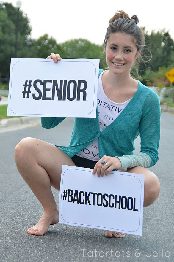 A teen holding a sign that says #senior