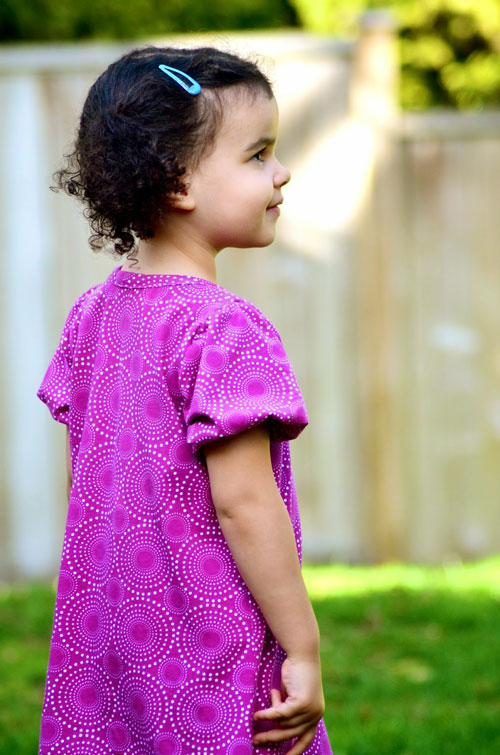 A little girl wearing a pink dress