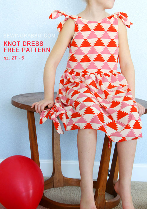 A girl sitting on a chair wearing the knot dress