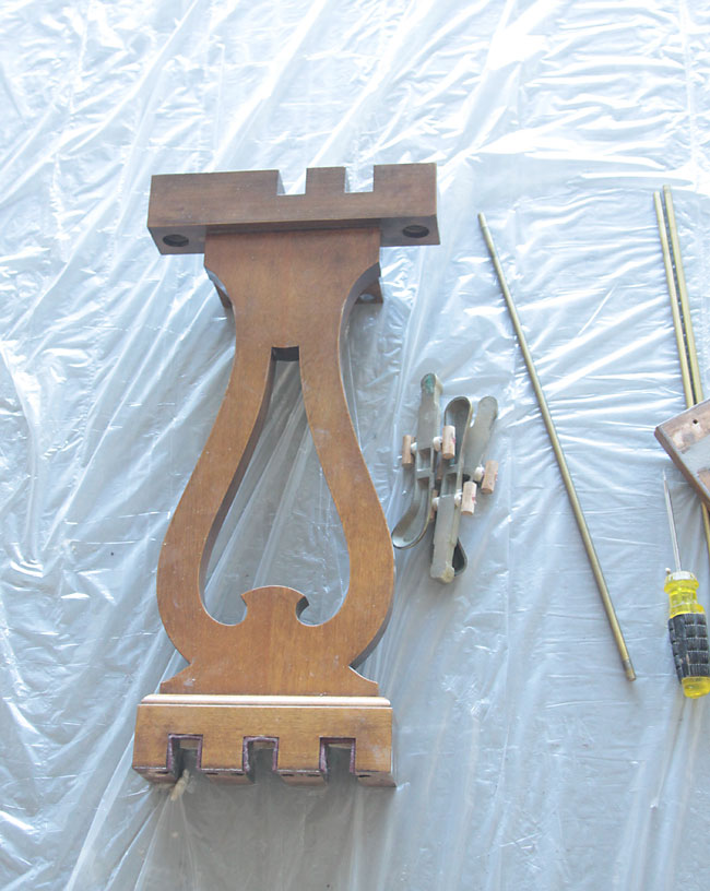 Pieces removed from a piano on a plastic sheet