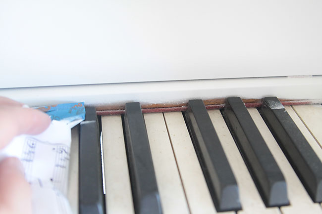 Removing tape from piano keyboard