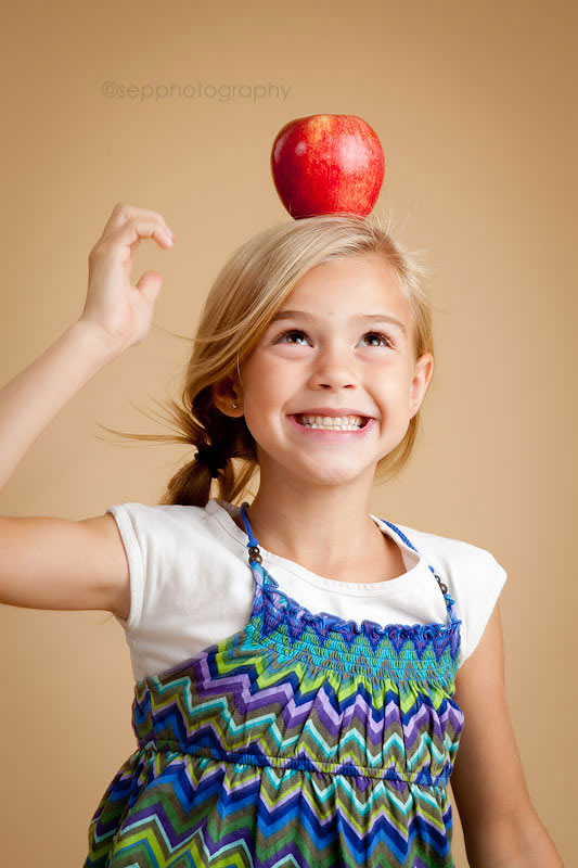 Girl with an apple on her head