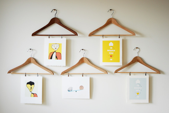 DIY photo display using prints hung from wood clothes hangers
