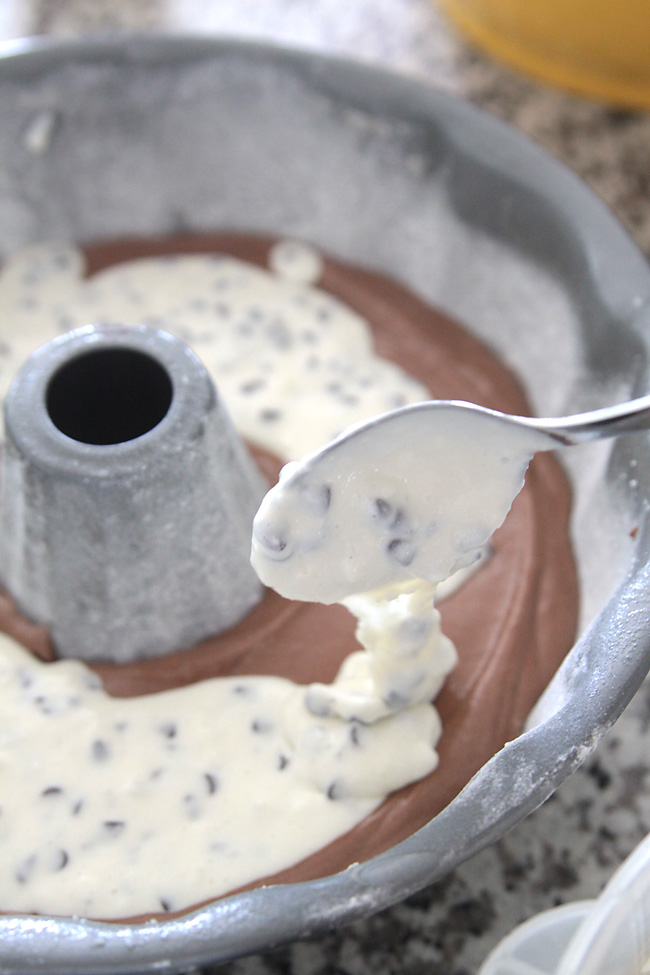 Chocolate cake batter in a bundt pan topped with cream cheese batter