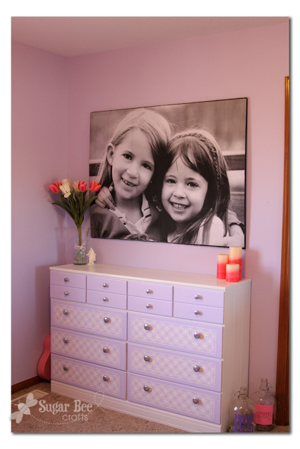 Very large canvas photo of two girls hanging over a dresser