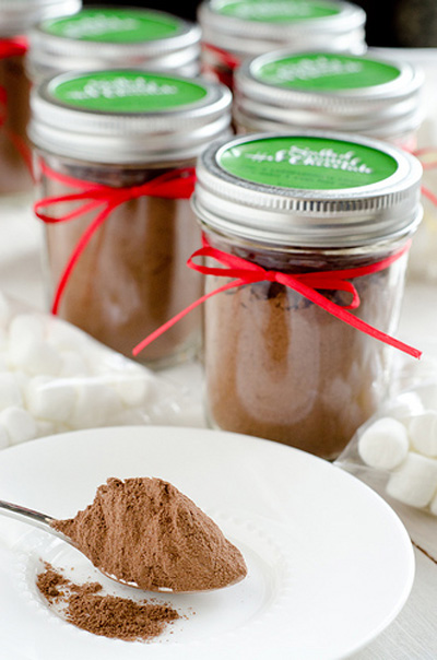 Homemade hot chocolate mix in a small mason jar tied with red ribbon as a gift