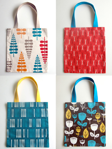 Four handmade fabric totes in brightly patterned fabric