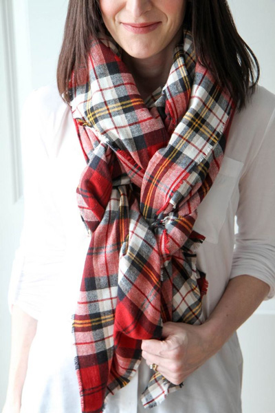 A women wearing a red plaid blanket scarf