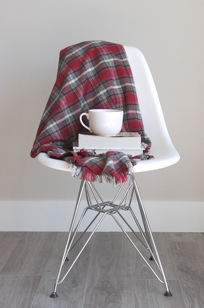 Fringed flannel throw draped over a chair