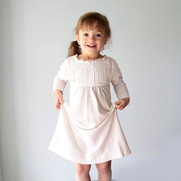 A little girl wearing a nightgown